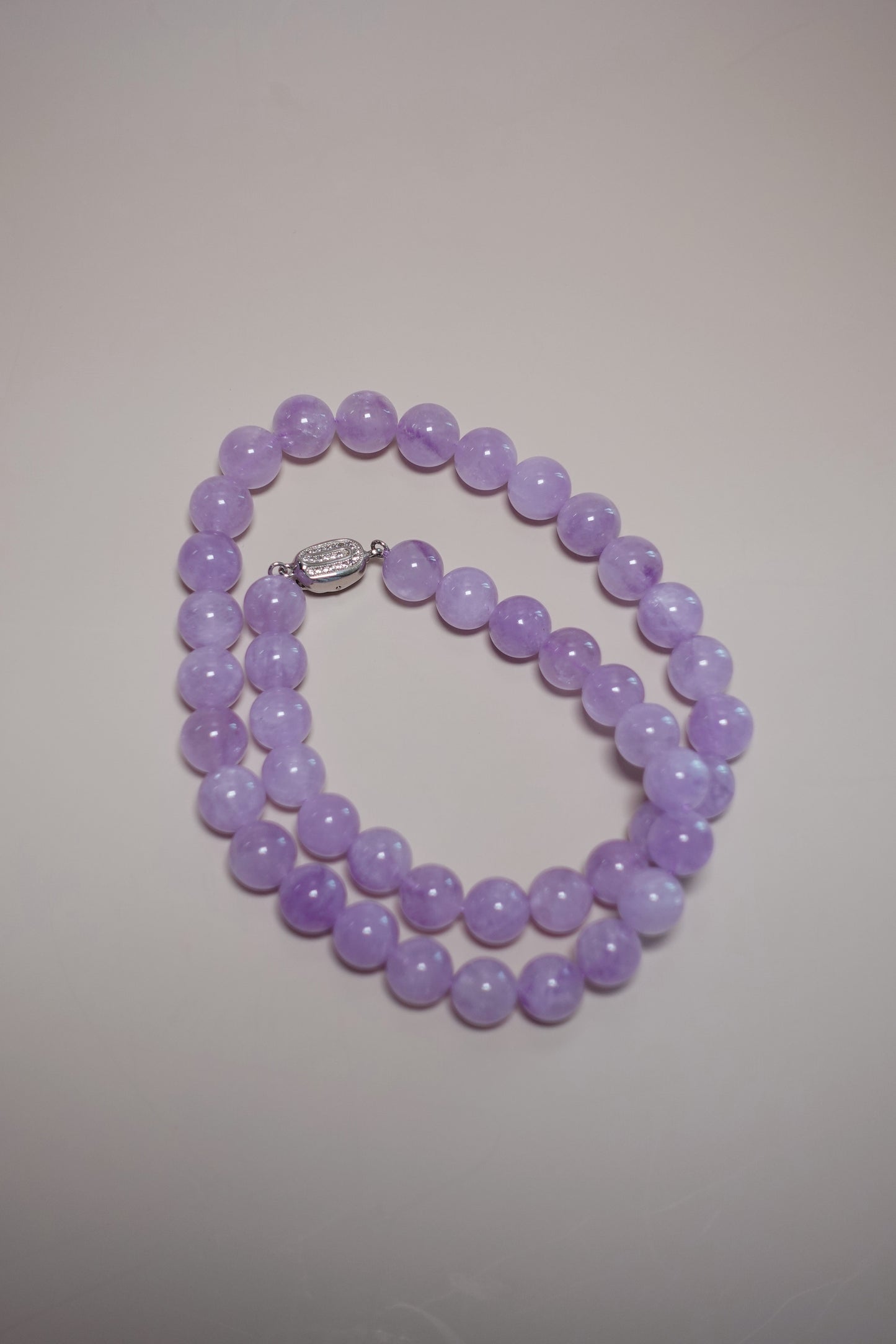 12 mm natural lavender amethyst necklace by Between Dust Creations with white gold–plated silver clasp.
