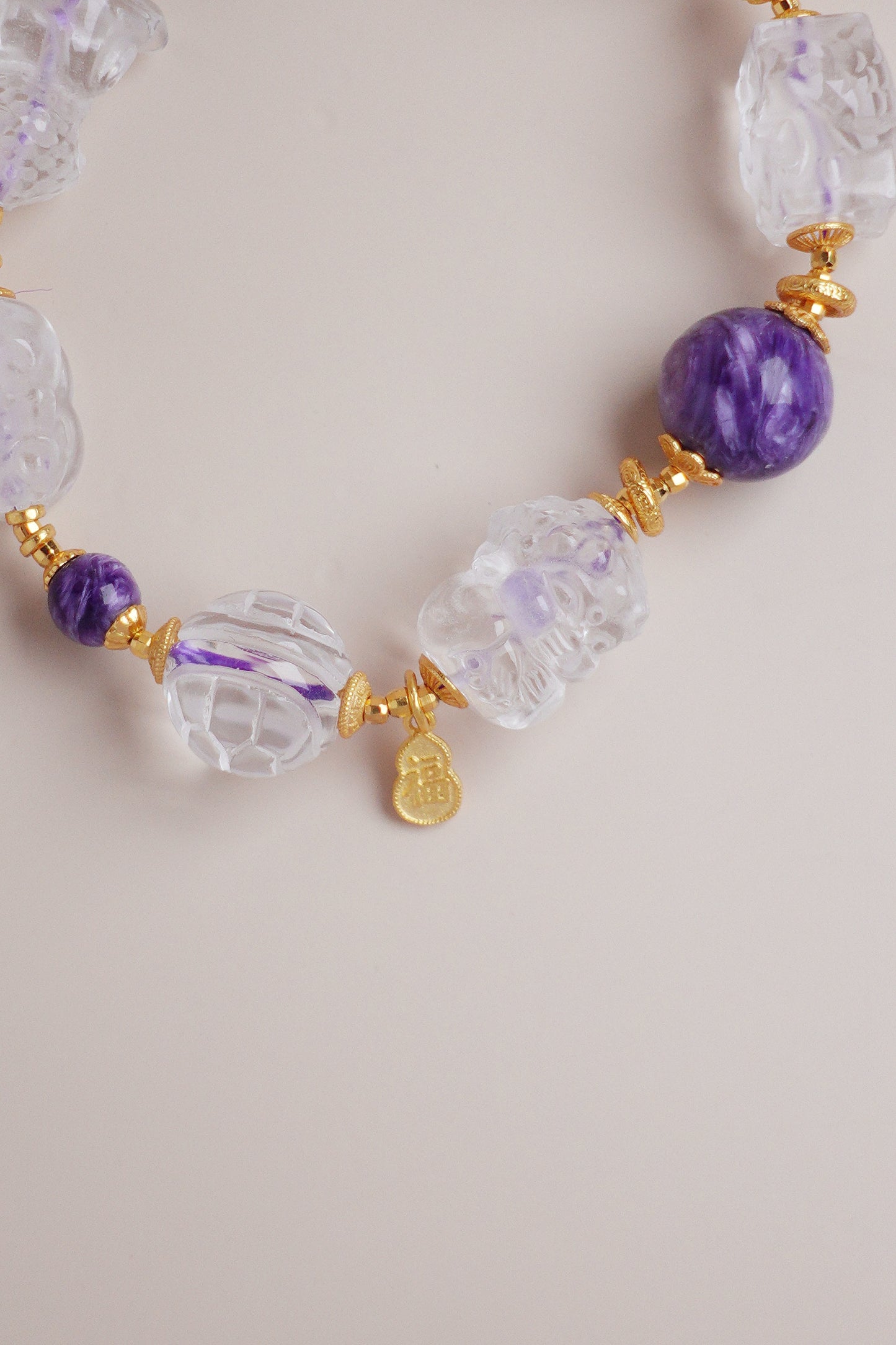 24k gold vermeil on sterling sliver bracelet with purple charoite beads and white quartz carved blessings charms, including a ‘Fu’ gourd