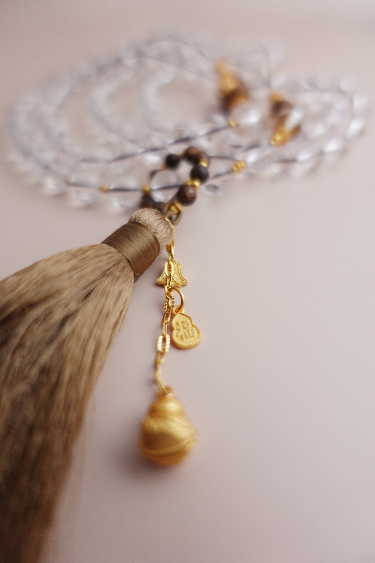 Adjustable white quartz & agarwood beaded necklace featuring a sliding loop and gold vermeil silver ‘Fu’ gourd charm