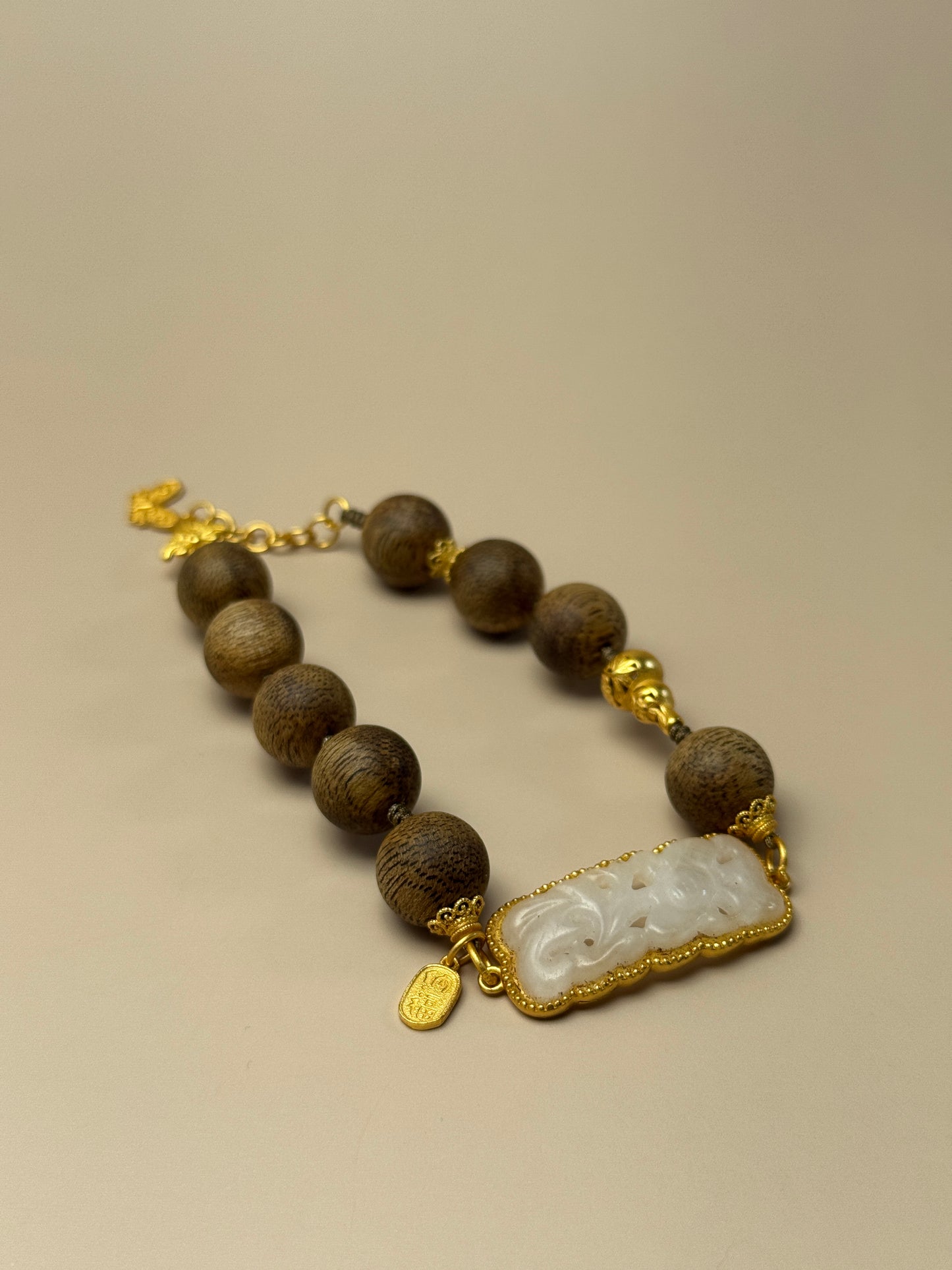 Agarwood and white jade bracelet with floral plaque charm, feng shui jewelry for inner peace and heart chakra