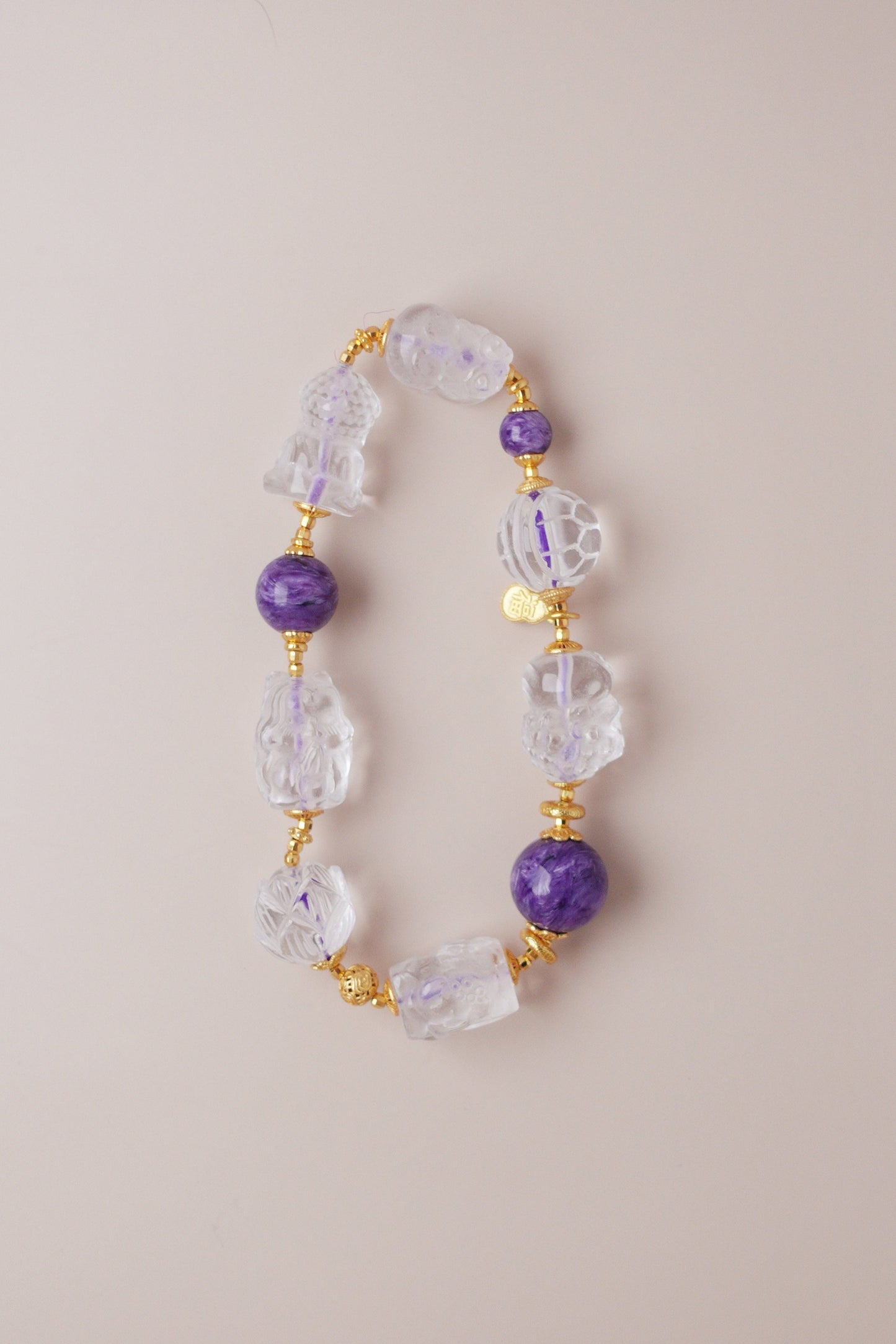 Charoite and clear quartz bracelet featuring Pixiu, nine‑tailed fox, lotus, koi, turtle shell, baby Buddha, and Tara carved charms