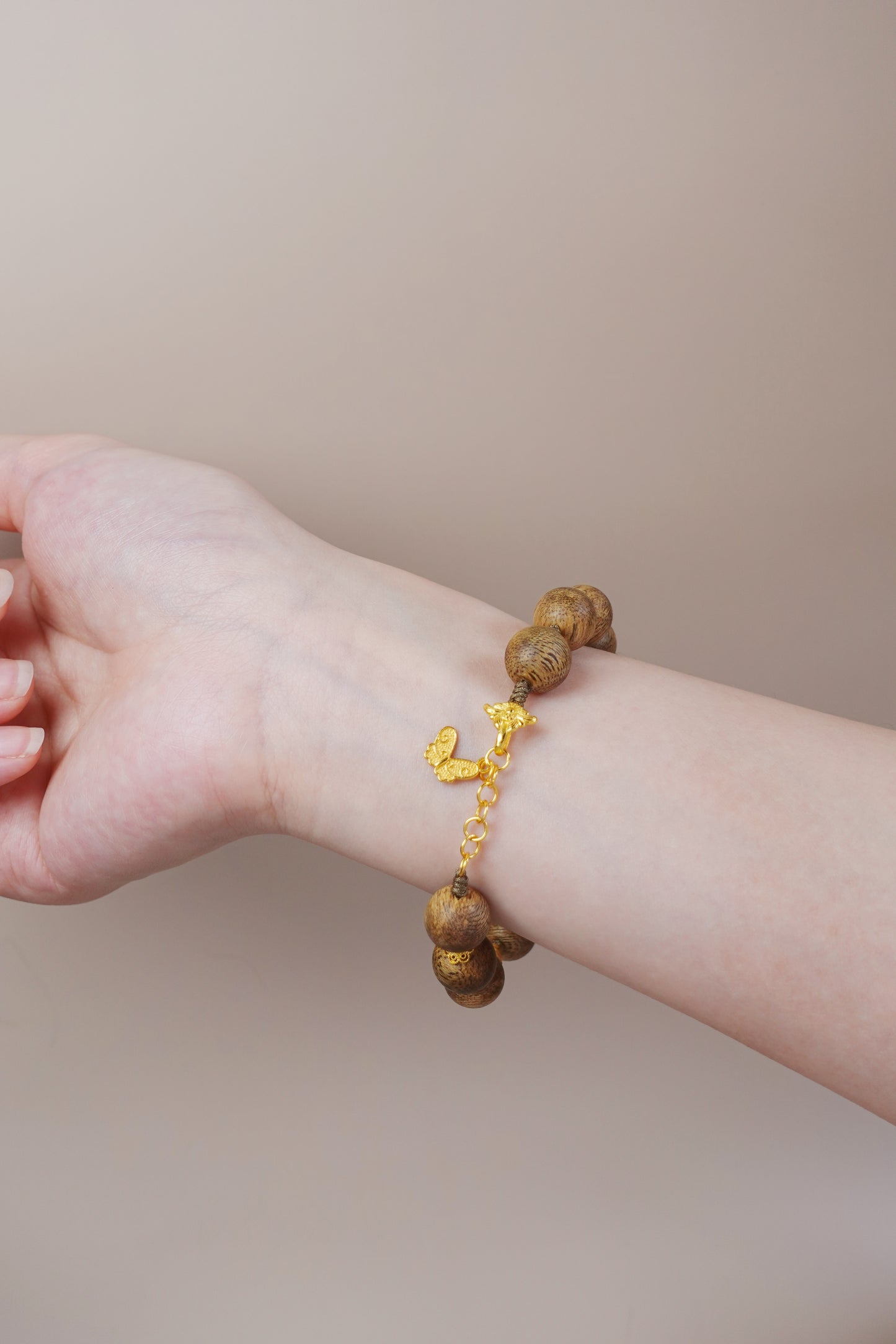 Gold vermeil accent on sterling silver paired with white jade and agarwood, symbolic feng shui jewelry