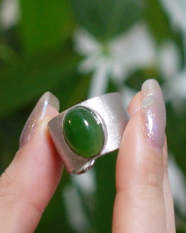 Close-up of rectangular Hetian jade in silver bezel, Chinese-inspired symbolic design