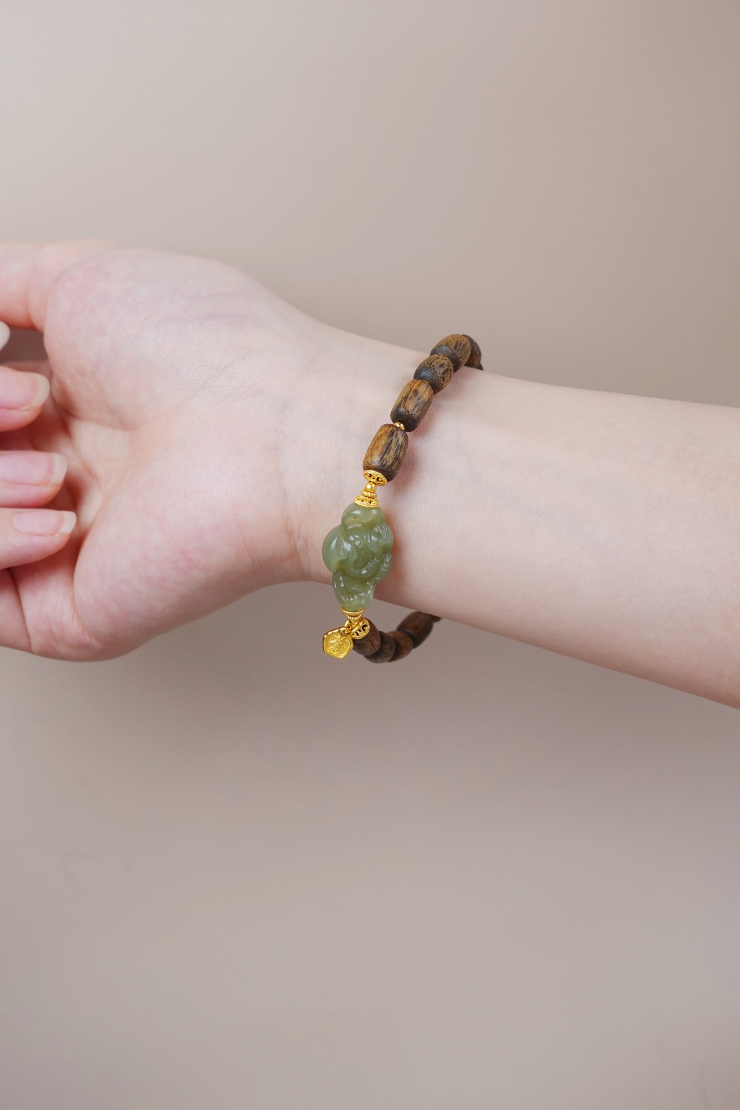 Wrist shot of agarwood and jade bracelet, natural gemstone jewelry for emotional healing and heart chakra