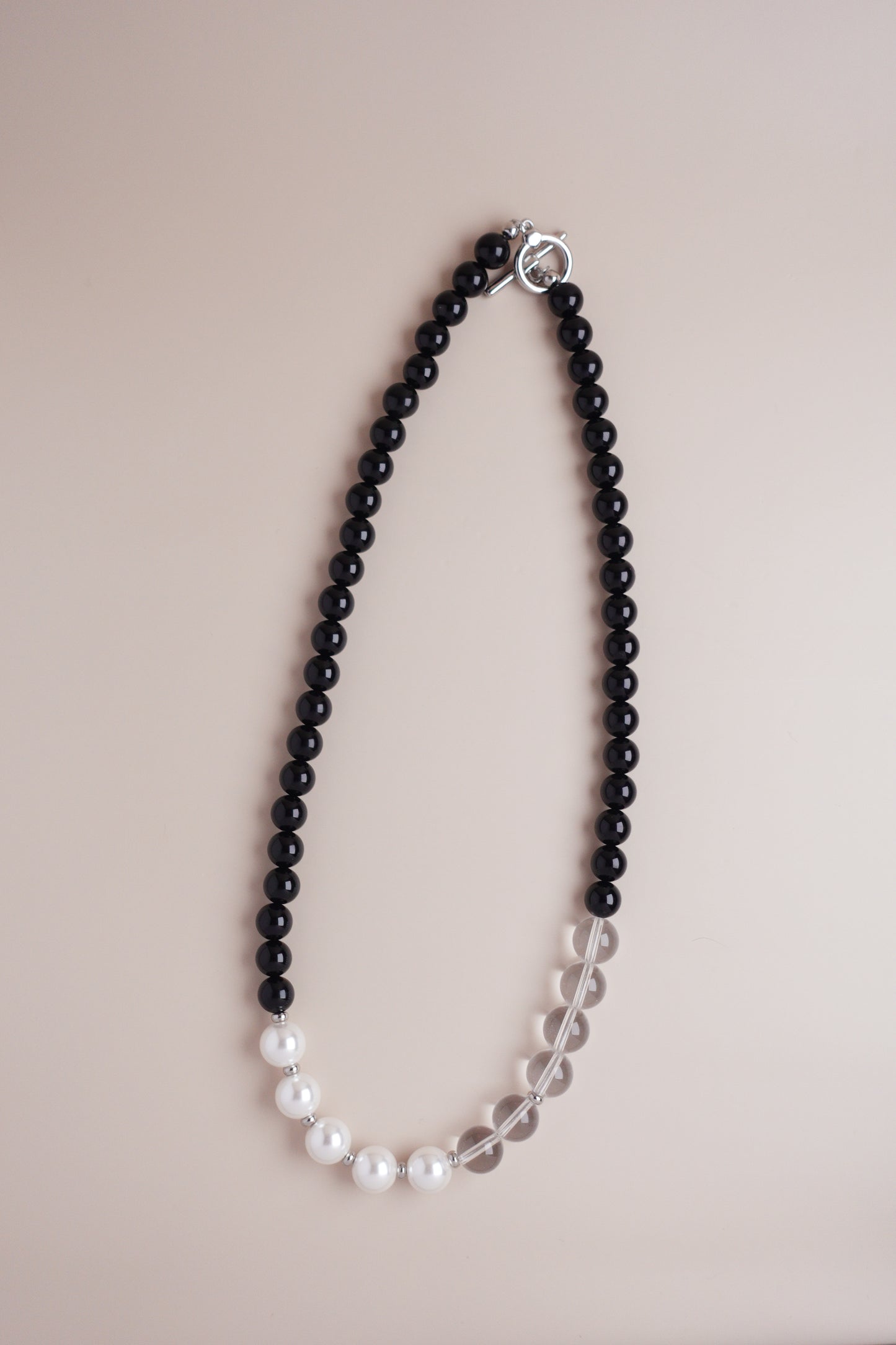 Yin-Yang beaded necklace featuring black onyx, Austrian imitation pearls, and clear quartz with titanium fittings.