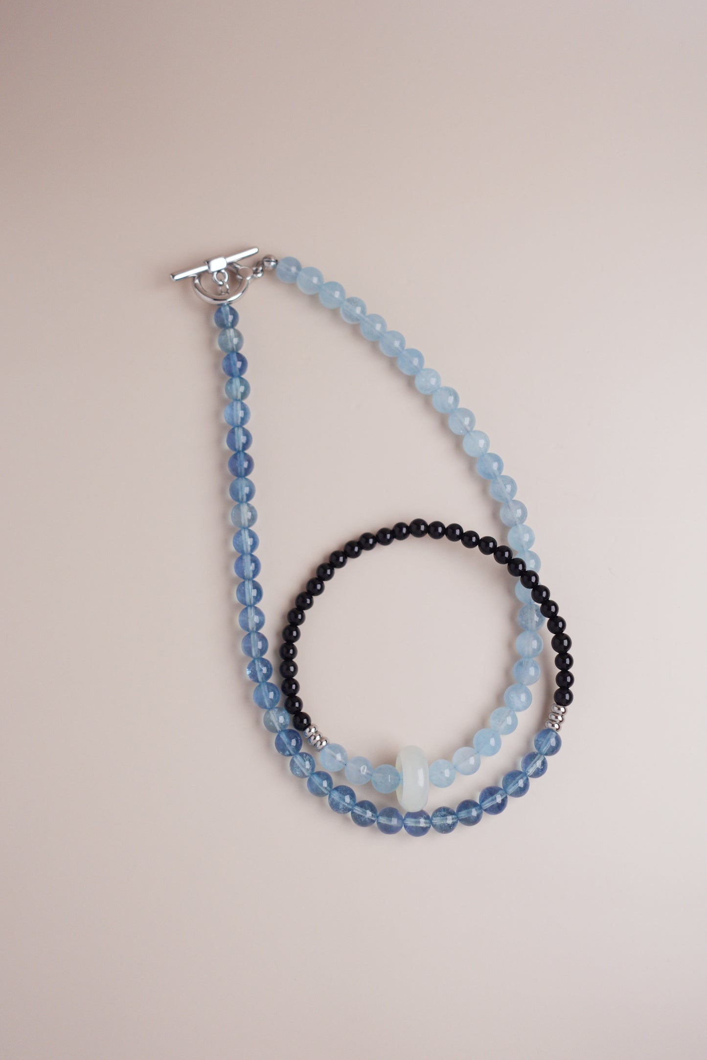Seaside Dusk gradient necklace of deep and light aquamarine beads paired with black onyx