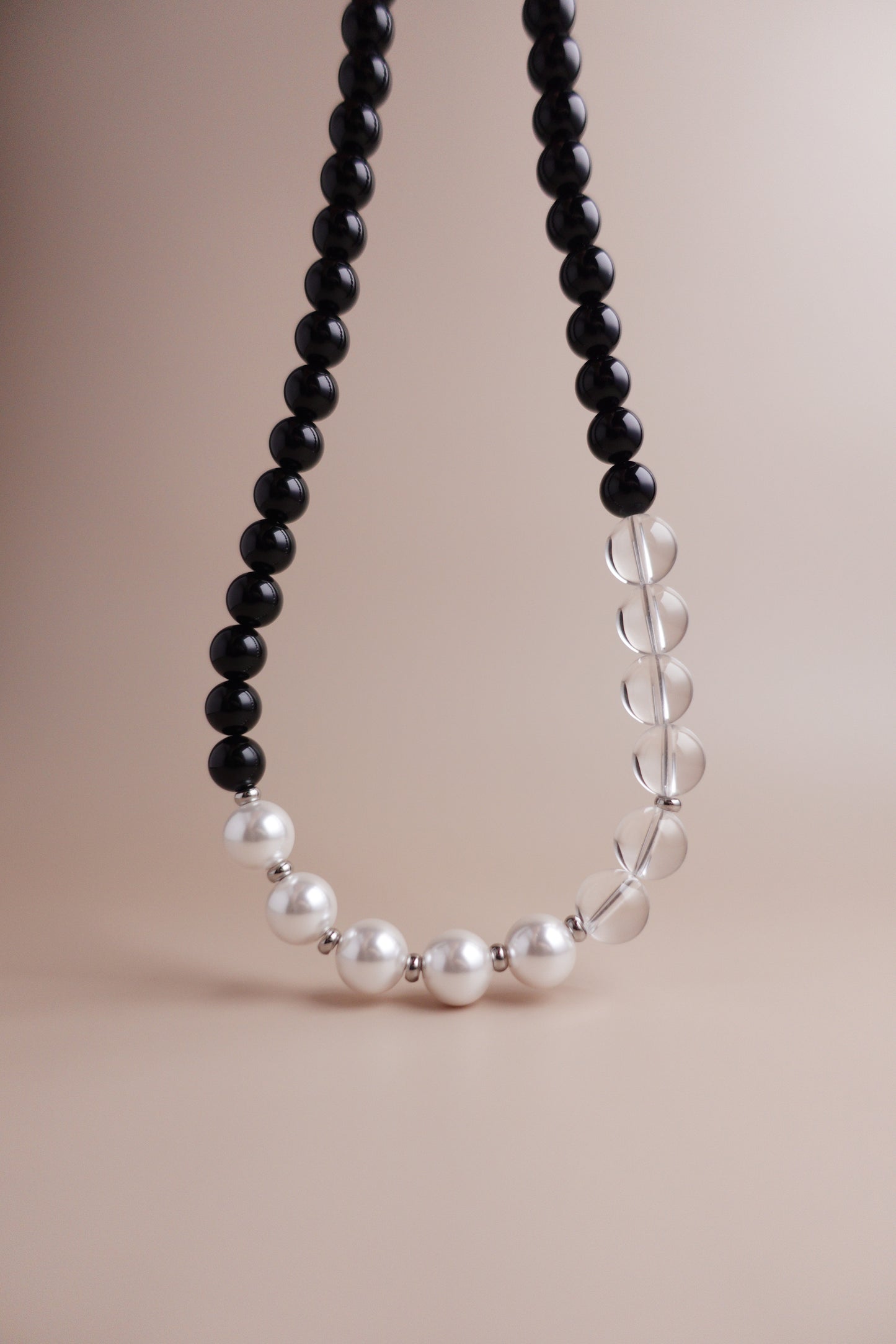 Waterproof, tarnish-resistant necklace of black onyx, clear quartz, and Austrian imitation pearls.