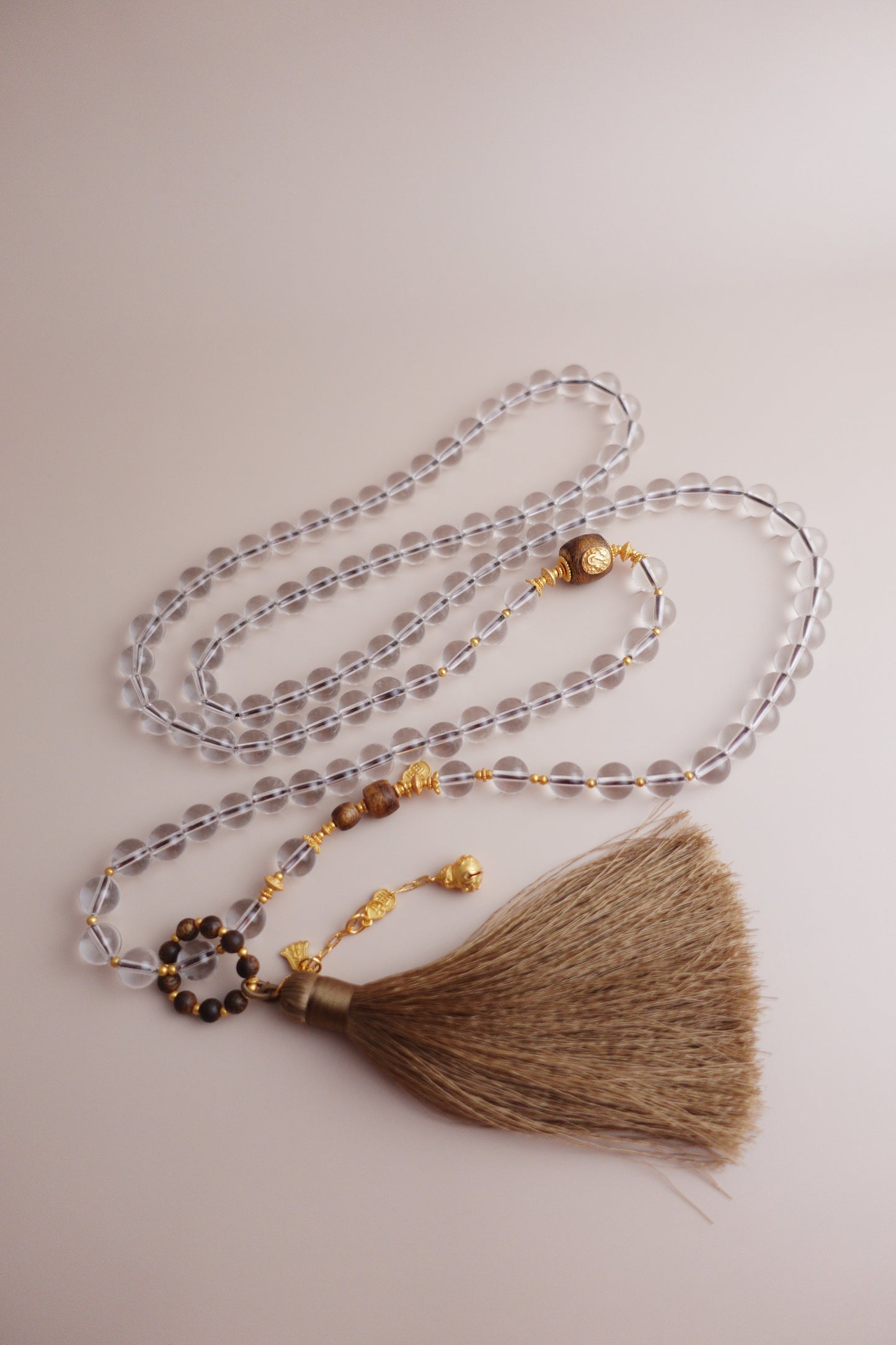 Guardian’s Whisper necklace of 8 mm white quartz and agarwood beads with a gourd ‘Fu’ charm and gold-vermeil S925 silver fittings