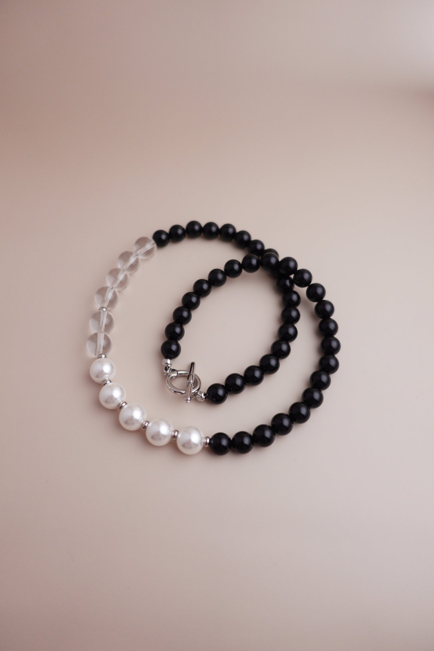 Yin-Yang Harmony necklace with black onyx and lustrous pearl and quartz beads.
