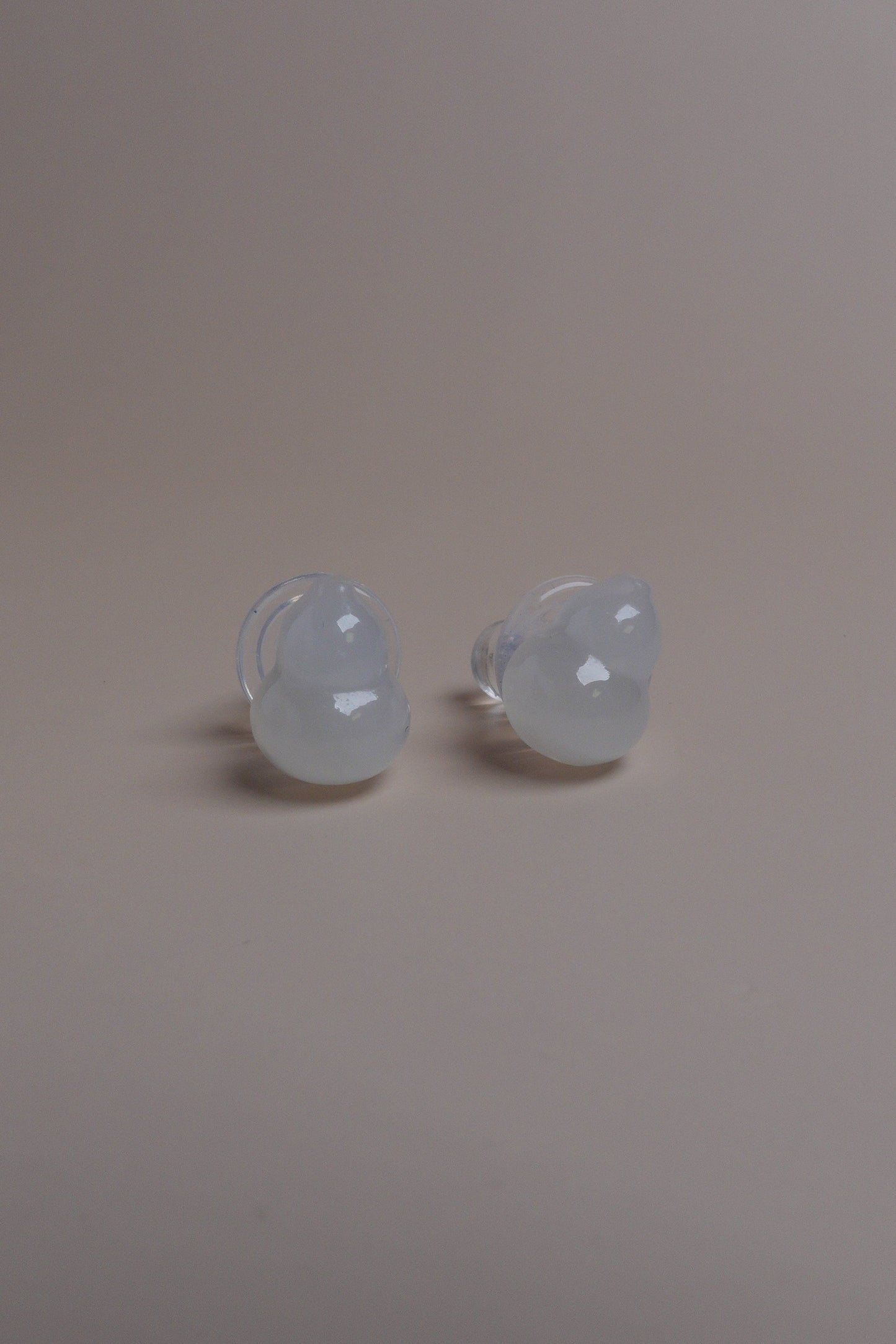 Two light bulbs on a plain wall