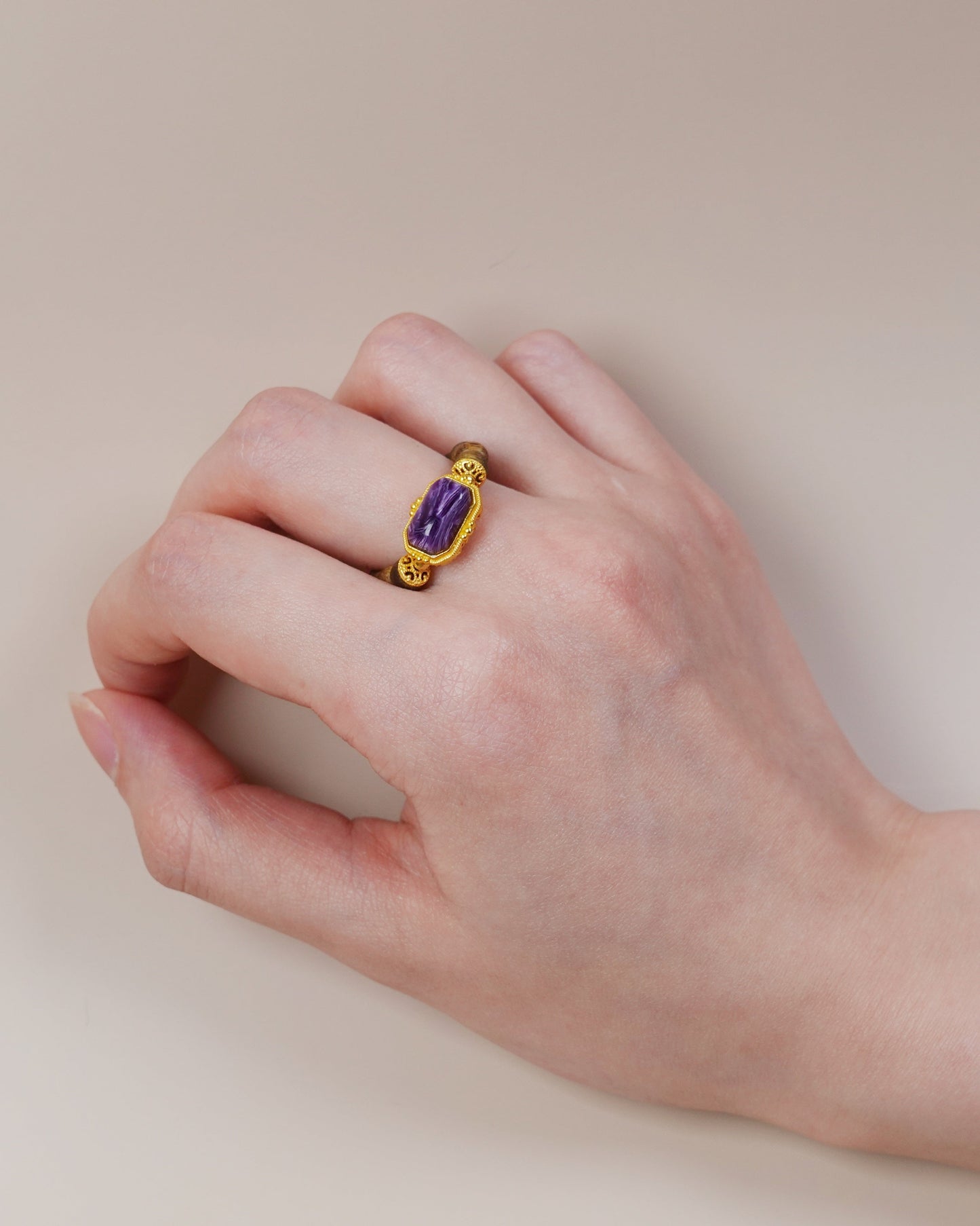Hand wearing charoite and agarwood ring, Third Eye Chakra jewelry with wood and gemstone pairing