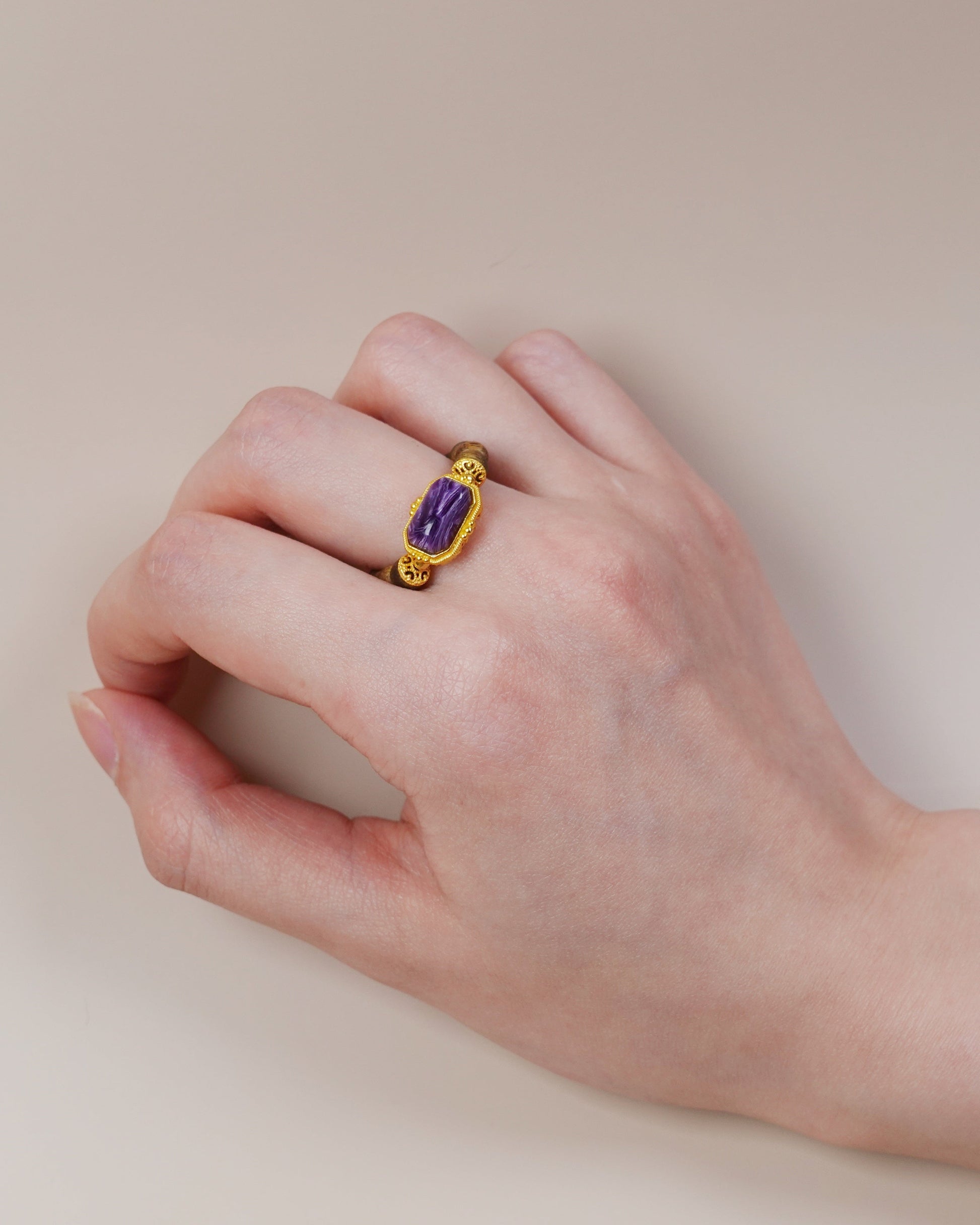 Hand wearing charoite and agarwood ring, Third Eye Chakra jewelry with wood and gemstone pairing
