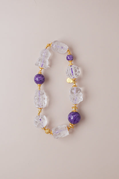 Charoite and clear quartz bracelet featuring Pixiu, nine‑tailed fox, lotus, koi, turtle shell, baby Buddha, and Tara carved charms