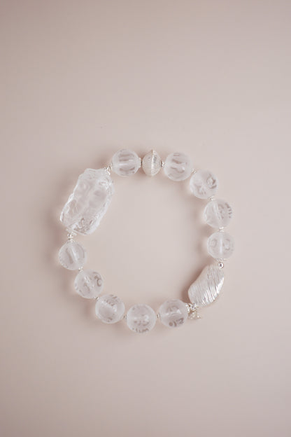 Frosted clear quartz bracelet with Om Mani Padme Hum engraving and carved Baby Tara charm on brushed S925 sterling silver.