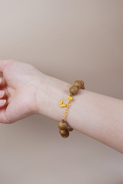 Gold vermeil accent on sterling silver paired with white jade and agarwood, symbolic feng shui jewelry