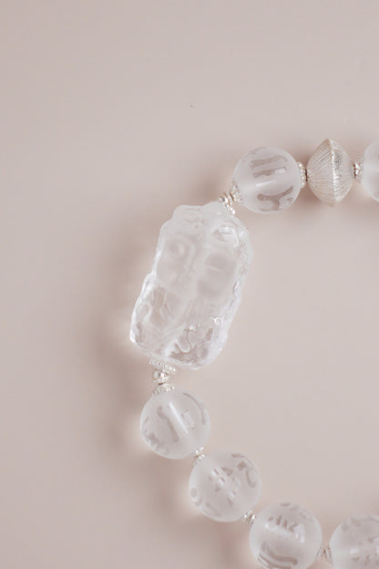 Om Mani Padme Hum mantra quartz bracelet featuring 10 mm frosted beads and Baby Tara carving with silver spacers.