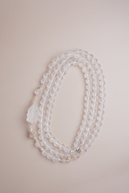 Quartz necklace featuring Om Mani Padme Hum mantra engraving and a frosted Baby Ganesha carving.