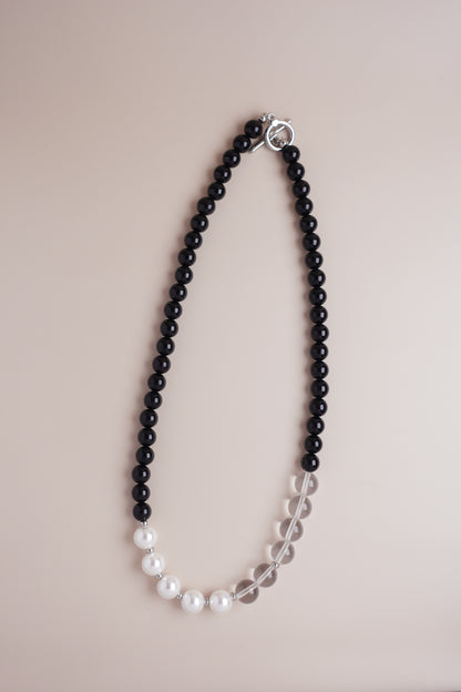 Yin-Yang beaded necklace featuring black onyx, Austrian imitation pearls, and clear quartz with titanium fittings.