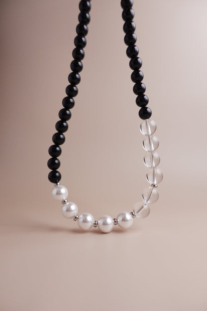Waterproof, tarnish-resistant necklace of black onyx, clear quartz, and Austrian imitation pearls.