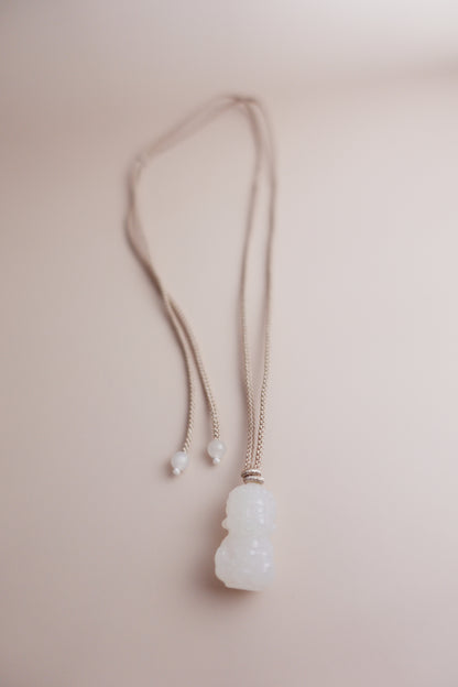 Adjustable hand-braided cord necklace with a hand-carved Hetian white jade Baby Buddha pendant.