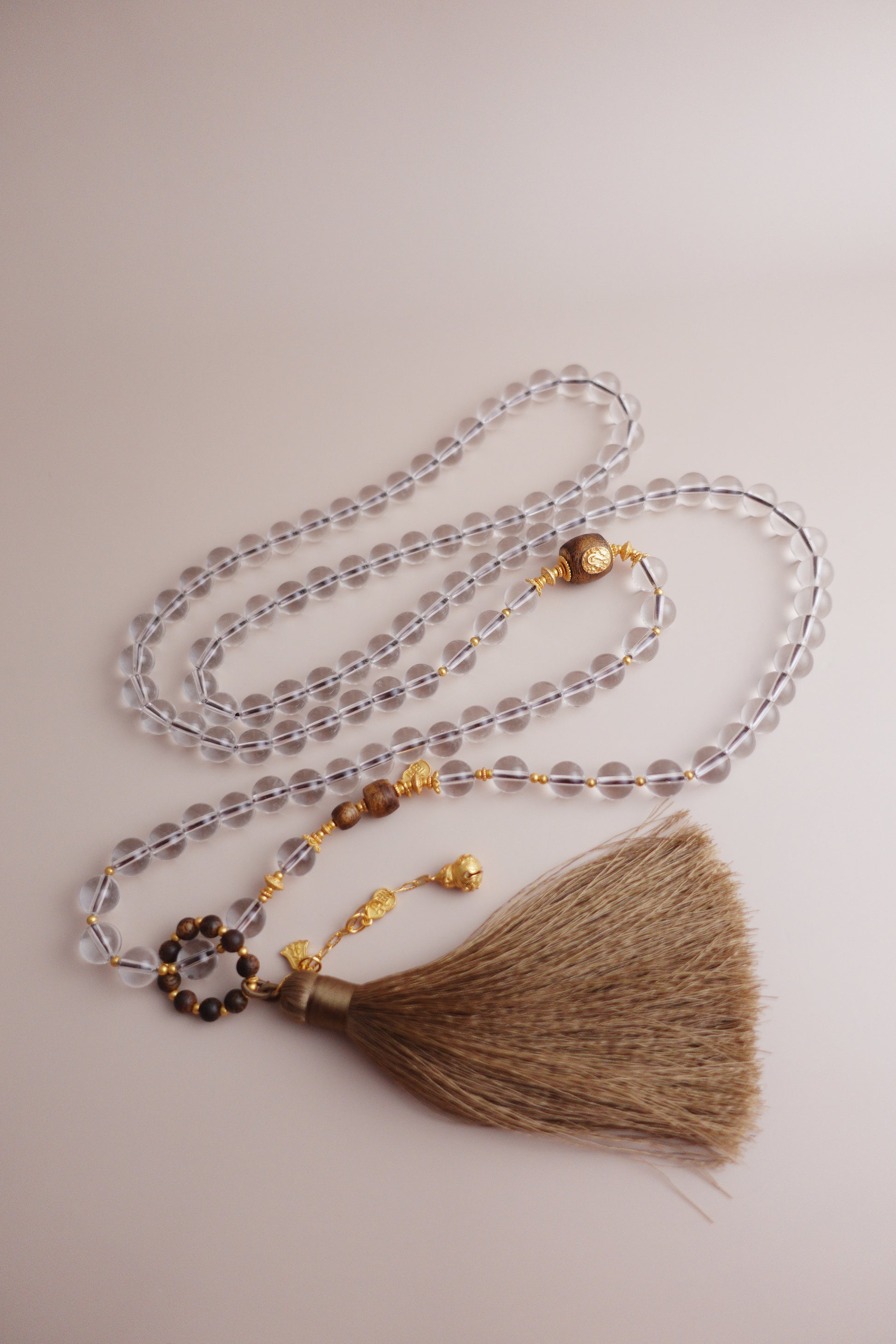 Guardian’s Whisper necklace of 8 mm white quartz and agarwood beads with a gourd ‘Fu’ charm and gold-vermeil S925 silver fittings